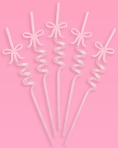 six white bows and ribbons on pink background