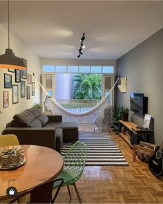 a living room filled with furniture and a hammock