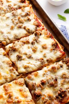 a pan filled with pizza sitting on top of a table