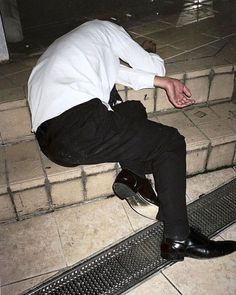 a man sitting on the steps with his feet up