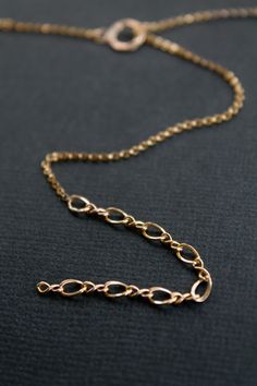 Four types of chain carefully soldered together into one striking lariat necklace. Sold individually Approximately 20.5" long 1.2mm Rolo Chain 1.5mm Long/Short Chain 3.3mm Figure 8 Chain 0.9x8.2mm Dapped Bar Chain Hammered ring closure 4 grams in weight Please expect slight imperfections, as this necklace is made by hand Gold Figaro Chain Lariat Necklace, Gold Lariat Figaro Chain Necklace, Gold Lariat Necklace With Cable Chain, Gold Dainty Long Drop Chain Necklace, Dainty Gold Long Drop Chain Necklace, Dainty Long Drop Gold Chain Necklace, Dainty Gold Chain Lariat Necklace, Dainty Lariat Necklace With Gold Chain, Dainty Gold Lariat Necklace