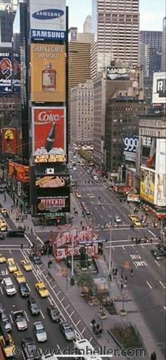 an aerial view of a busy city street with billboards on the buildings and traffic