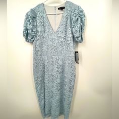 a light blue dress hanging on a hanger