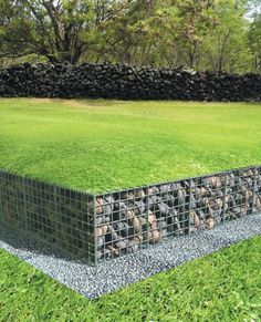 a large grassy field with rocks in the middle and grass growing on it's sides