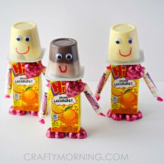 three small plastic figures made to look like they are holding candy