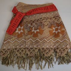 a piece of cloth with fringes and flowers on it