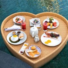 a heart shaped table with food and drinks on it in the shape of a heart