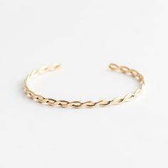 Our Braided Cuff is intricate, minimal, and meaningful! It symbolizes the intertwining of two lives, as well as your past and future self. The weaving pattern resembles the ups and downs of how you got to where you are today, and where you are going in the future. We love to wear it with our Minimal Cuff Bracelet for the perfect look. DETAILS Gold filled cuff (flat outside, rounded inside) 4mm width Adjustable - one size fits all Please note: there may be visible solder marks on the back of the Minimalist Braided Bangle Bracelet For Everyday, Minimalist Everyday Braided Bangle Bracelet, Elegant Jubilee Cuff Bracelet For Friendship, Gift Modern Twist Twisted Bracelets, Adjustable Bracelet With A Modern Twist, Modern Twist Cuff Bangle For Everyday, Braid Cuffs, Types Of Gold, Gold Bracelet Cuff