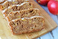 slices of apple bread sitting on top of a wooden cutting board next to an apple