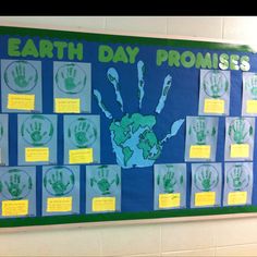 a bulletin board with handprints on it and the words earth day promises