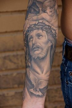 a man with a tattoo on his arm has a jesus face and doves above him