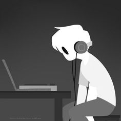 a person sitting at a desk with headphones in front of their face, using a laptop