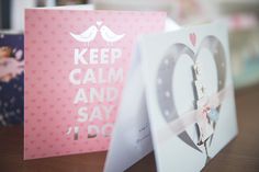 two greeting cards on a table with the words keep calm and say i love you