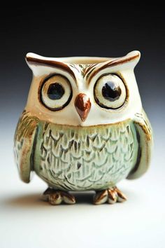 an owl figurine sitting on top of a table