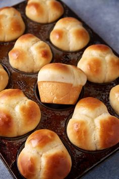 freshly baked bread rolls in a muffin tin ready to be baked into the oven