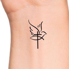 a small tattoo on the wrist of a woman's arm with a cross and dove