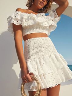 Make a statement with the Suri Two Pieces Set! This stylish set features delicate embroidery and flirty ruffle details, perfect for showing off your unique style. The off-shoulder neckline and high-rise design add a touch of femininity, while the cotton material ensures comfort. The crop top and short skirt length make it a versatile ensemble for any occasion. Specs: Material: Cotton Summer Sets With Ruffled Skirt, Summer Party Sets With Ruffles, Chic Off-shoulder Spring Sets, Casual Off-shoulder Sets, Chic Off-shoulder Summer Sets, Elegant Summer Set With Ruffles, Elegant Summer Sets With Ruffles, Elegant Ruffled Summer Sets, Elegant Summer Ruffled Sets