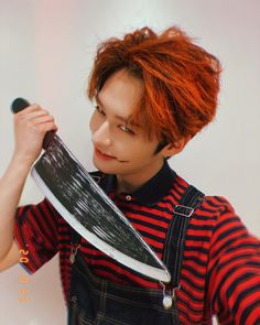 a man with red hair holding a large knife