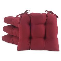 three red cushions with ties on them