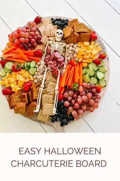 a halloween platter with fruit, crackers and cheeses in the shape of a skeleton