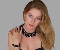 "This Chunky Black Chain Link Choker with its Swarovski rectangle crystals beads is a statement piece of jewelry. With its flat chain and large resin links, it is a bold and eye-catching accessory. Perfect for adding a touch of edginess to any outfit, this choker is sure to become a staple in your jewelry collection. The black color gives it a versatile and timeless appeal, while the chunky design adds a touch of modern style. Whether dressed up or down, this necklace is sure to make a big impac Elegant Black Chain Link Jewelry, Black Link Necklaces With Gold Chain, Modern Black Chain Necklace For Party, Black Link Necklace With Gold Chain, Chunky Chain Link Choker For Party, Trendy Black Chain Link Jewelry, Bold Chunky Chain Jewelry For Party, Chic Chunky Chain Jewelry For Evening, Bold Chunky Chain Party Jewelry