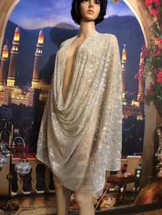 This bright silver Egyptian assuit wedding shawl is in mint condition!  It is extra long 95 inches long and a full 33 inches wide! Embellished with dazzling bright silver thread featuring 9  filled diamonds and classic Egyptian motifs of people, plants, camels, geometric art deco designs, and more. It is a medium-weight shawl with no holes, tears or tarnish, which is amazing for a 100-year-old wedding shawl so the storage must have been impeccable.  Made for a well-to-do bride or perhaps a tourist in the 30's, this one has both the diamonds AND the Classic motifs as well. Hand-rolled edges,  wide embellished ends, chevron borders, and hundreds of smaller diamonds fill the shawl. Bellydancers, flappers, and Egyptian revivalists love these to wear as shawls, drapes, or scarves. Simply stunni Festive Party Shawl With Sequins, Fitted Silver Sheer Dupatta, Glamorous Party Shawl, Festive Wedding Shawl With Sequins, Fitted Shawl For Party And Festive Occasions, Elegant Fitted Silver Dupatta, Elegant Silver Sequin Dupatta, Elegant Long Dupatta For Party, Traditional Evening Shawl With Traditional Drape