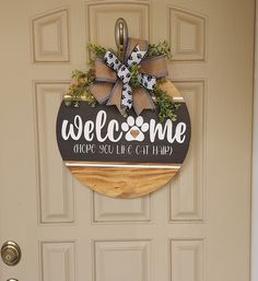 a welcome sign hangs on the front door