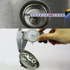 a person holding a watch in front of a measuring tape on top of a machine