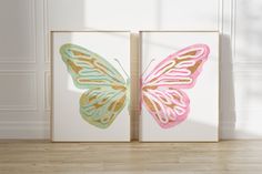 two butterfly paintings are shown in front of a white wall with wood flooring and wooden floors