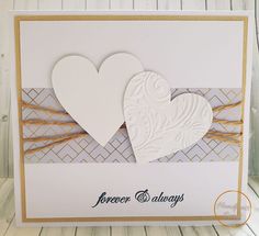 two paper hearts on a white card that says forever and always with gold trim around the edges