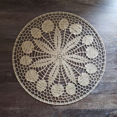 a white doily sitting on top of a wooden table