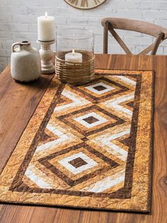 a wooden table topped with a brown and white area rug next to a candle holder