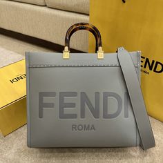 Description FND Tote Bag Grey For Women, Wonmen’s Bags 13.8in/35cm FF 8BH386ABVLF1BZC Rep 1:1 Medium Sunshine Shopper bag grey with hot-stamped “FND ROMA” and stiff tortoiseshell plexiglass handles. Equipped with a spacious lined internal compartment. Size 35 x 17 x 31 cm / 13.8 x 6.7 x 12.2 inches (Length x Height x Width) Gray. Gold-finish metalware The two handles and detachable shoulder strap. Can be carried by hand or worn on the shoulder. Include dust bag. This product is of the best quali Fendi Tote Bag, Fendi Tote, Longchamp Bag, Fendi Bag, Celine Bag, Shopper Bag, Sierra Leone, Fendi Bags, Grey Leather