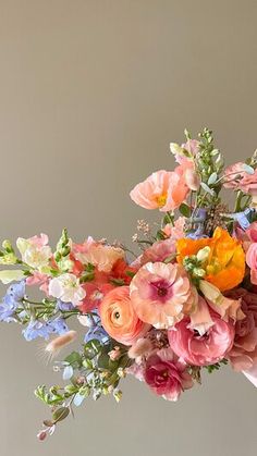 a woman holding a bouquet of flowers in her hand