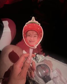 a person holding a lollipop in their hand with a photo on it's side