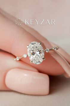 a woman's hand with a diamond ring on top of her finger and the words key