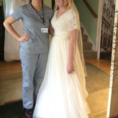 two women standing next to each other in front of a doorway wearing scrubs and wedding dresses