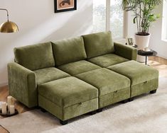 a green couch sitting on top of a white rug