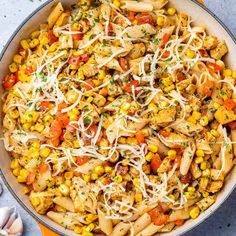 a skillet filled with pasta and vegetables