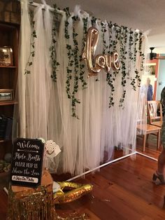 an image of a room decorated with balloons and greenery