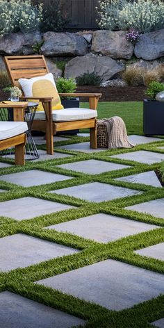 an outdoor patio with grass and wooden furniture