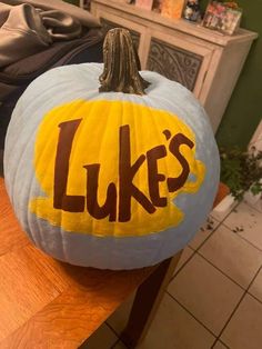 a pumpkin with the word luke's painted on it