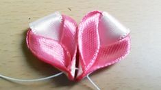 two pieces of pink fabric sitting on top of a table