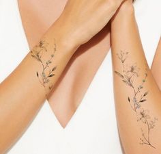 two women with matching tattoos on their arms