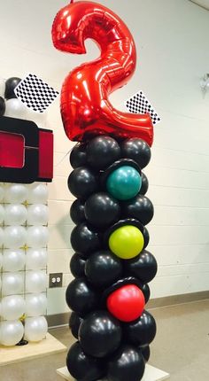 some balloons are stacked on top of each other in the shape of numbers and symbols