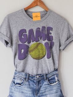 a t - shirt that says game day with a baseball on it and the words game boy written in purple