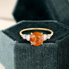 Sunstone Ring, 14k Solid Gold Ring, Orange Sunstone Ring with Moissanite, Engagement Ring, Gift For Her, Natural Sunstone Ring for Women  (in stock) - Metal: 14K Yellow Gold - Custom Color: Rose Gold, Yellow Gold, and White Gold  - Gross weight: 2.65g - Gold Weight: 2.49g - Gemstones: Sunstone, Moissanite - Sunstone CTW: 1.43(1pcs) - Sunstone size: 6.1 mm - Moissanite CTW: 0.80 (4pcs) - Ring size: 7 - Ring Width: 1.4mm - Ring Thickness: 1.4mm  - Ring Width: 20.67mm Approximately - Ring Height: 2 Fine Jewelry Orange Diamond Ring, Orange Sapphire Round Ring, Round Citrine Gemstones For Anniversary, Promise Ring With Citrine Center Stone, Citrine Rings With Accent Stones In Round Cut, Moissanite Birthstone Ring For Anniversary, Wedding Citrine Gemstones With Center Stone, Moissanite Gemstone Ring Round Cut, Citrine Rings With Accent Stones Round Cut