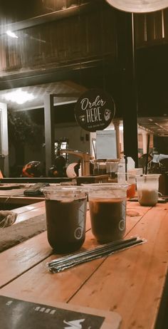 two coffee cups sitting on top of a wooden table