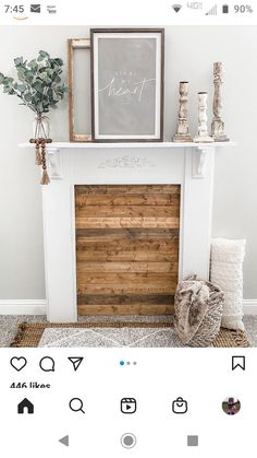 a white fireplace with a wooden mantel