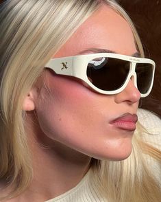 a blonde woman with sunglasses on her face